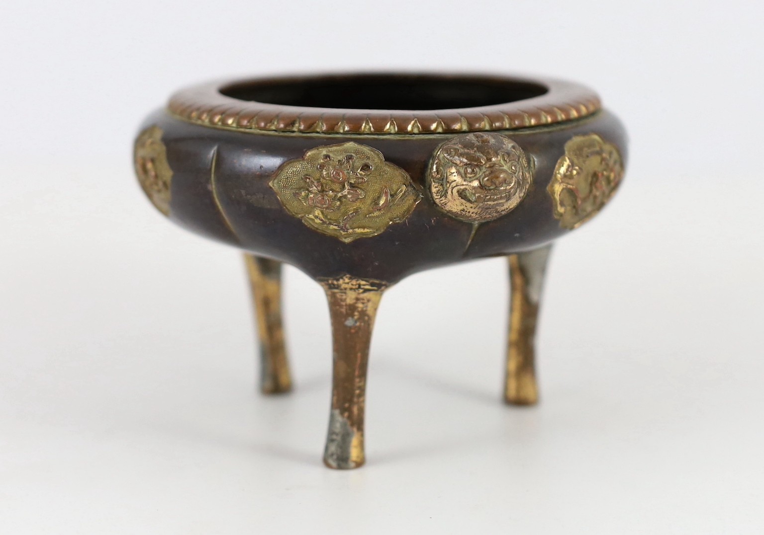 A Chinese Imperial copper alloy censer, ding, 18th century, 12cm wide 7cm high, ring handles and cover lacking, some wear.